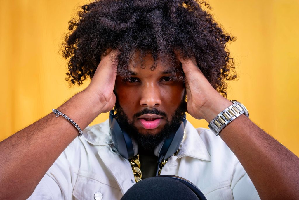 Young man holding head experiencing stress and headache